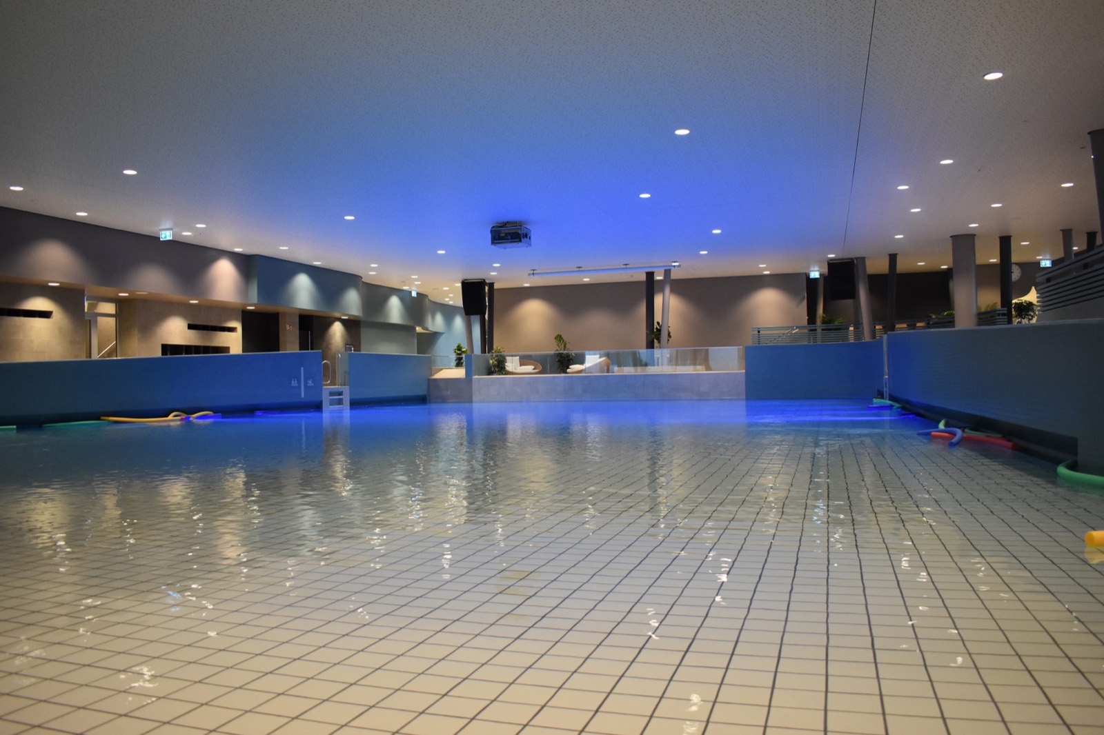 Gefliestes Schwimmbecken mit blauer Beleuchtung